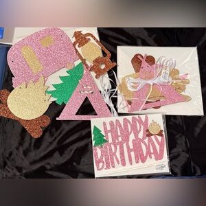 Set of glittery pink and gold Camping-themed birthday party decorations
